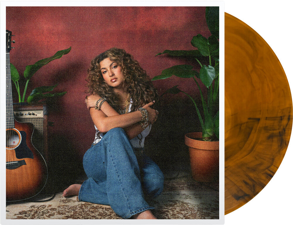 the album cover for Tori Kelly - God Must Really Love Me [Translucent Orange with Black Swirls]