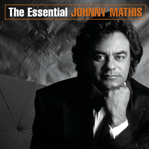 the album cover for Johnny Mathis - The Essential Johnny Mathis